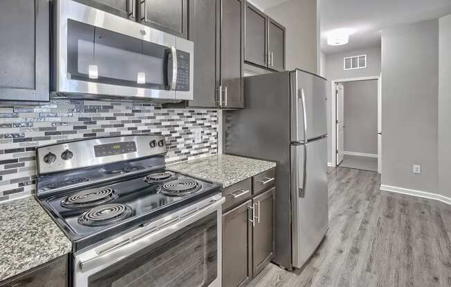 a kitchen with stainless steel appliances and granite counter tops at Nexus at Sandhill, Columbia South Carolina