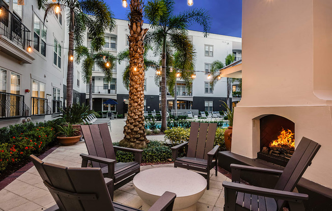 A patio with chairs and a fireplace.