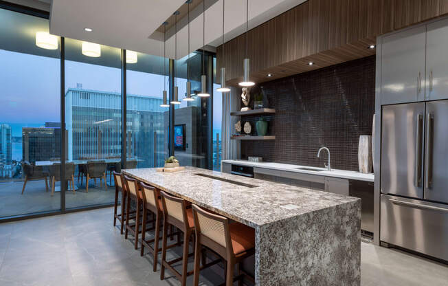 a kitchen with a large island with a granite countertop at Stanza Little Italy, San Diego, CA
