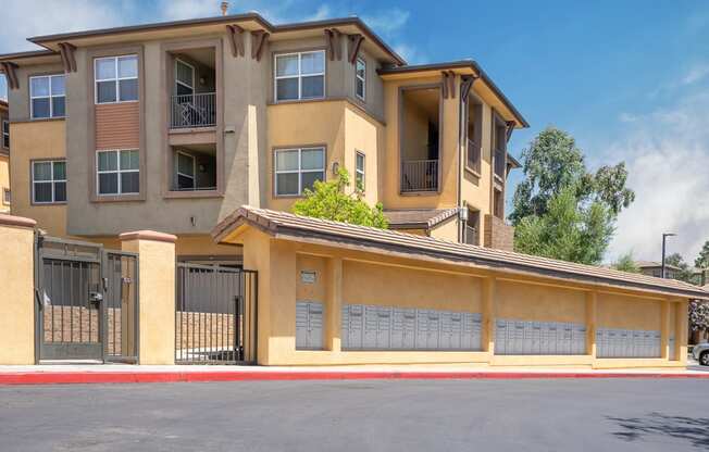 an apartment building with a garage on a sunny day