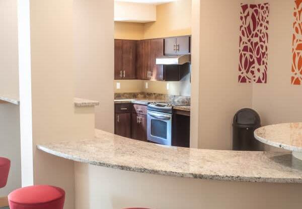 A bar area with red stools and a counter.