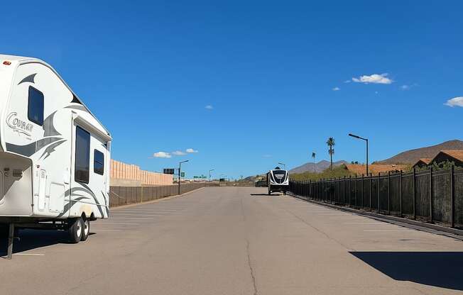 A white RV is parked on the side of a road.