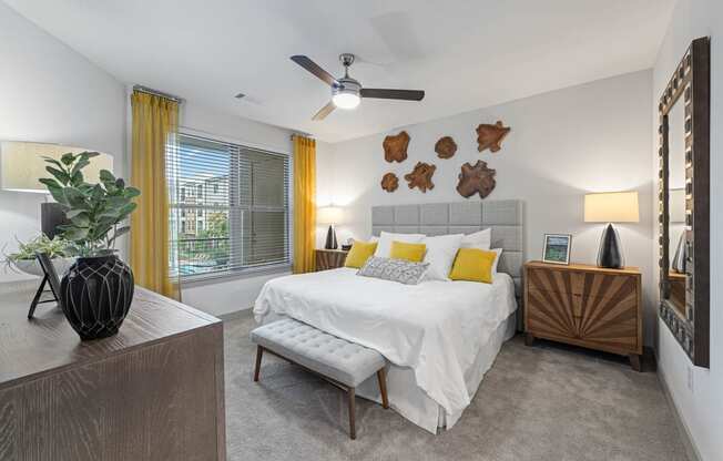 a bedroom with a bed and a ceiling fan