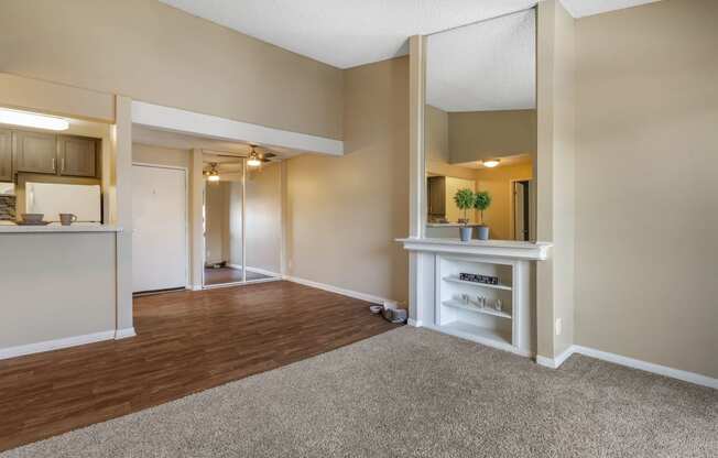 a living room with a kitchen in the background