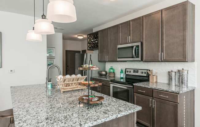 a kitchen with granite counter tops and wooden cabinets at Village at Westland Cove Apartments, Tennessee, 37922