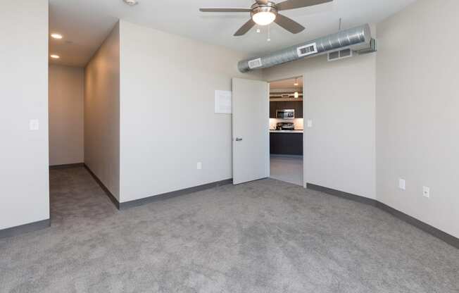 Bright, vacant bedroom with neutral walls and carpet flooring.