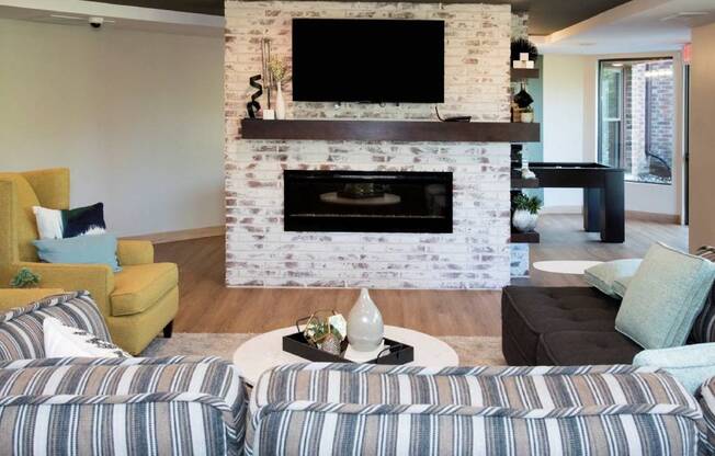 Couch, fireplace, tv, lounge in community room at Aspenwood Apartments, Eagan, MN