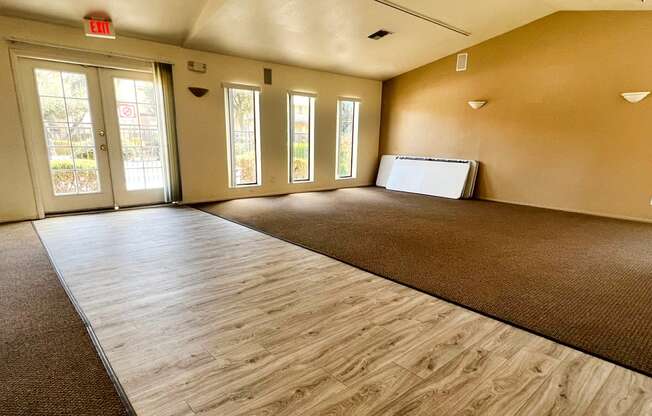 an empty living room with a couch and a refrigerator