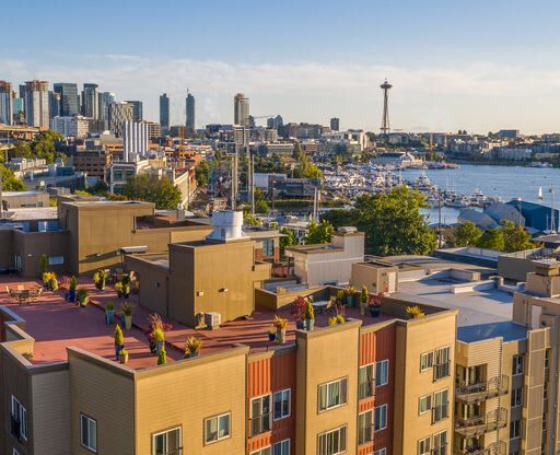 View from the Resident Rooftop Deck of a Puget Sound and the city of Seattle in the background at Illumina Apartment Homes, Washington, 98102