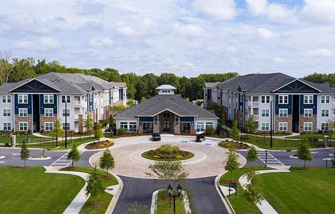 an aerial view of an apartment complex with a circular courtyard at Promenade at Newnan Crossing, Newnan, 30265