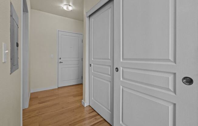 a bedroom with white doors and a door to a closet