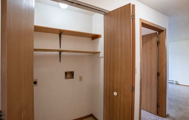 an empty room with a closet and an open door. Fargo, ND  Prairie Park Apartments