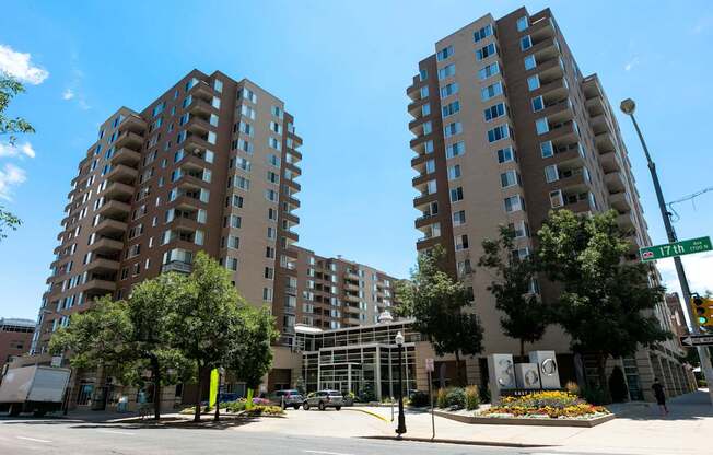 an empty street in front of two large apartment buildings