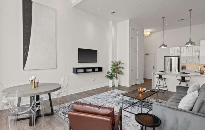 a living room with white walls and hardwood floors