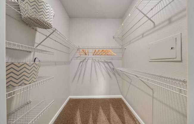 A long hallway with a carpeted floor and a metal railing on the right side.