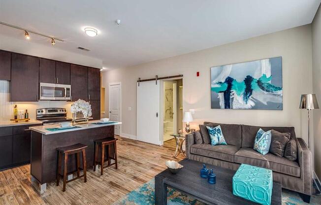 a living room with a couch and a kitchen