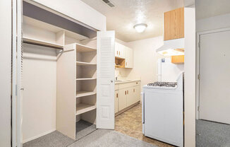 kitchen with white appliances and a closet