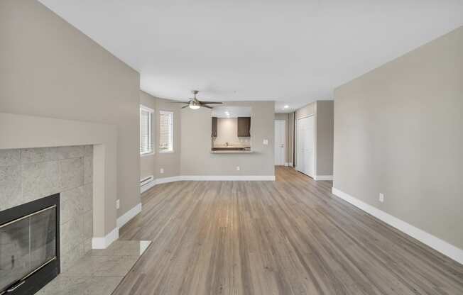 an empty living room with a fireplace and a tv