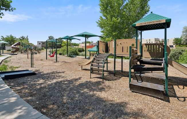 a playground with a swing set and other playground equipment