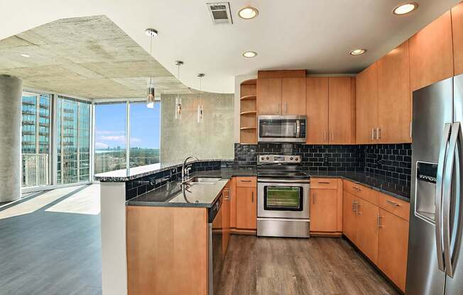 A modern kitchen with wooden cabinets and stainless steel appliances.