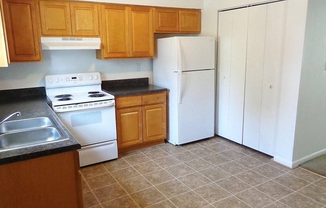 a kitchen with a stove refrigerator and a sink