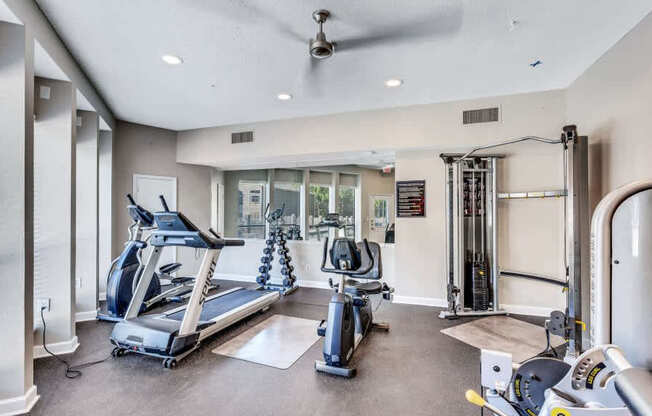 A spacious gym with treadmills, elliptical machines, and other exercise equipment.