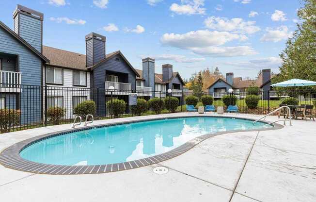 a swimming pool with apartments in the background