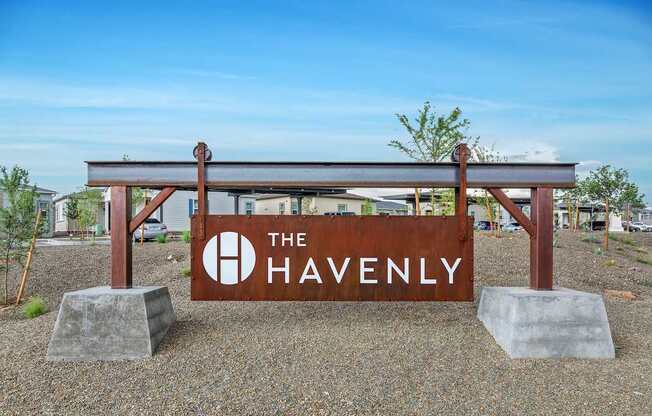 A sign that says "The Havenly" is in front of a building.