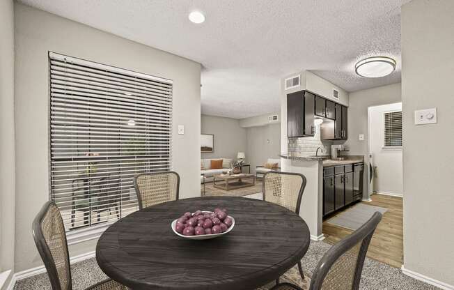 a dining room table with a bowl of fruit on it at Legacy Apartments in Plano, TX