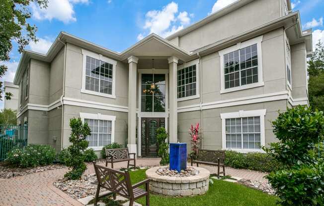 Apartments for Rent in Houston - Exterior View of The Maroneal Leasing Office With Outdoor Fountain, Benches and Lush Greenery