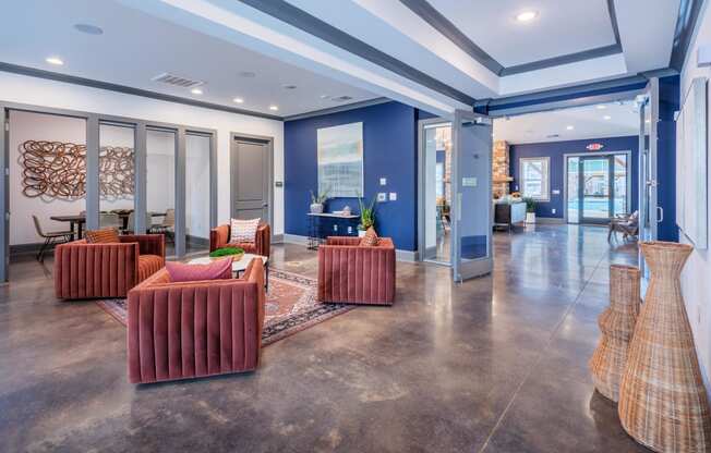 a lobby with couches and chairs and glass doors