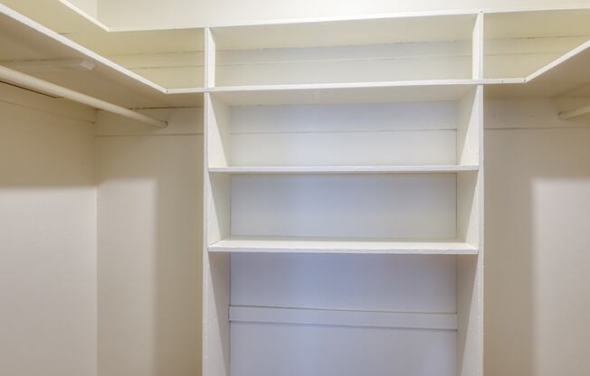 a walk in closet with white shelving and white walls at Gates of West Bay in Norfolk, VA 23503