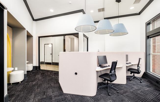 a large office area with desks and chairs and a partition