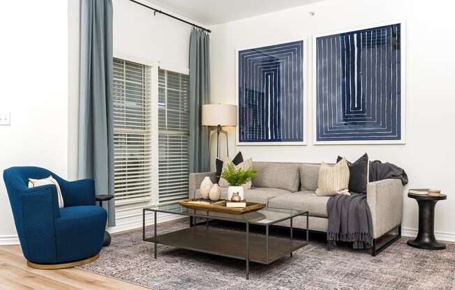 a living room with white walls and blue curtains