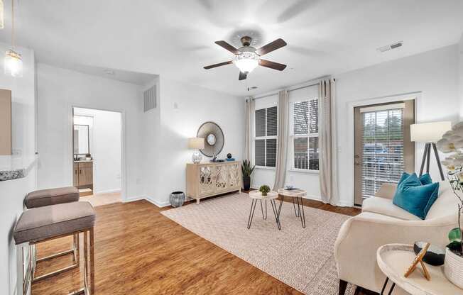 a living room with a couch and a ceiling fan