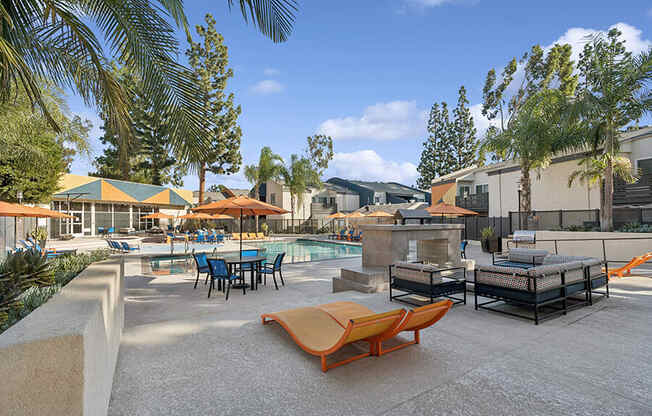 Community Swimming Pool with Pool Furniture at Horizon Apartments located in Santa Ana, CA.