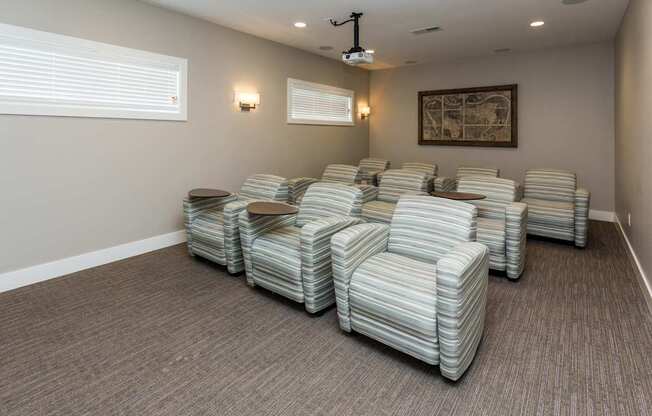 A room with striped chairs and a projector.