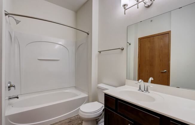 a bathroom with a sink toilet and a tub