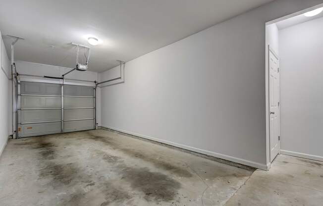 a large room with a concrete floor and white walls