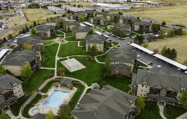 A large housing complex with a swimming pool in the middle.