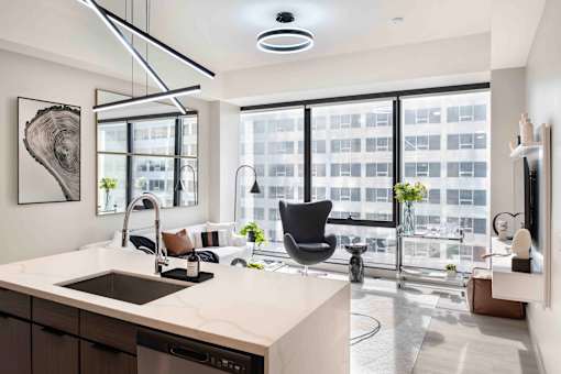 a kitchen and living room with a large window at 220 Meridian, Indianapolis, IN 46204