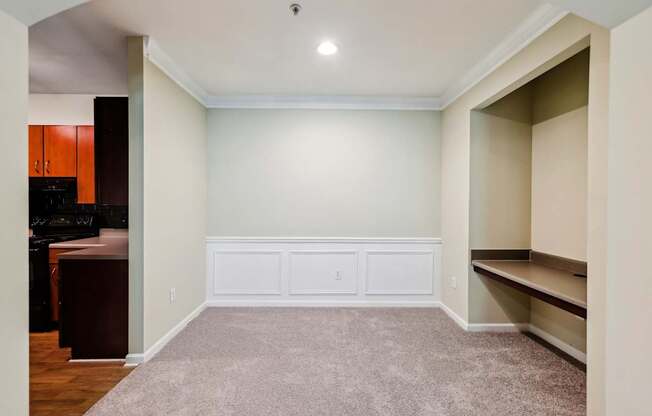 Dining room with a built in desk area next to it.