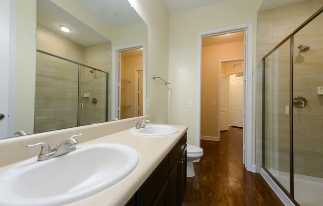 a bathroom with a large mirror and two sinks  at Alaqua, Florida, 32258