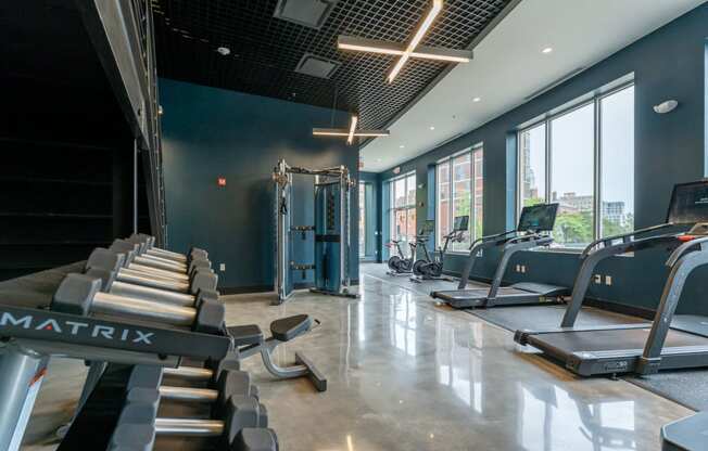 a fitness center with treadmills and other exercise equipment at park row west