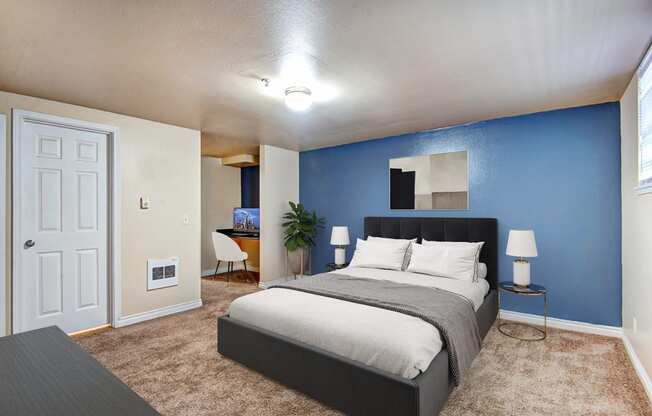 a bedroom with a bed and a blue wall