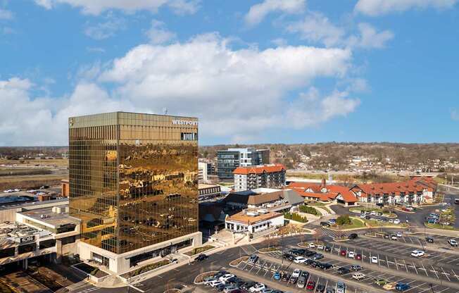 A large building with the word "METRO" on it is surrounded by other buildings and a parking lot.