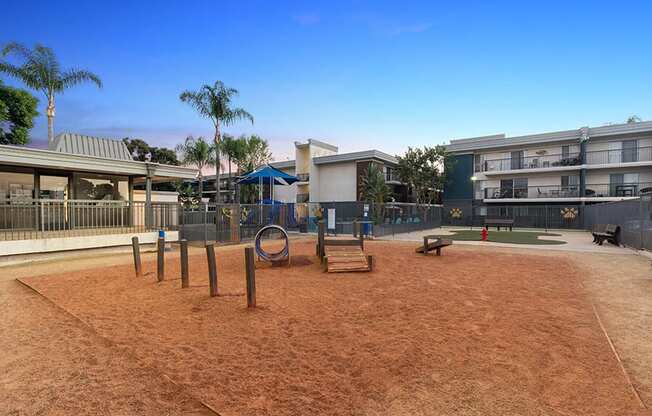 Community Dog Park with Agility Equipment at Madison Park Apartments located in Anaheim, CA.