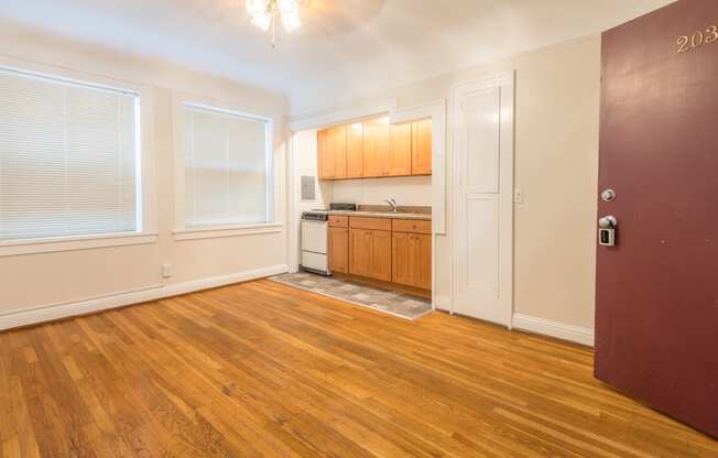 a kitchen and living room with wood flooring and a door