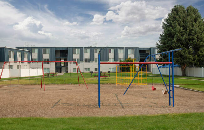 a playground in front of an apartment building