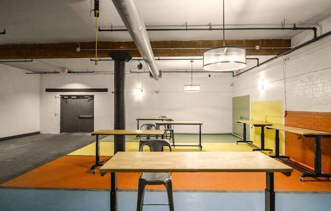 A room with a table and chairs in the center.